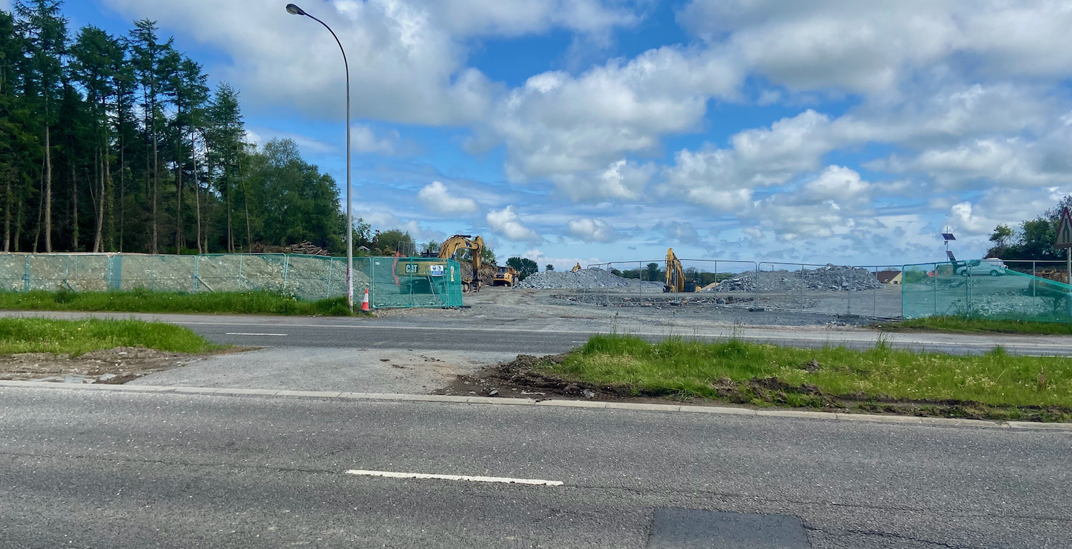 View across the A21 with excavators in
                          the distance and bare rock visible.