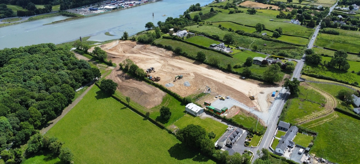 River in upper left, existing road on
                          bottom right. Large field between them is
                          completely brown having been dug over.