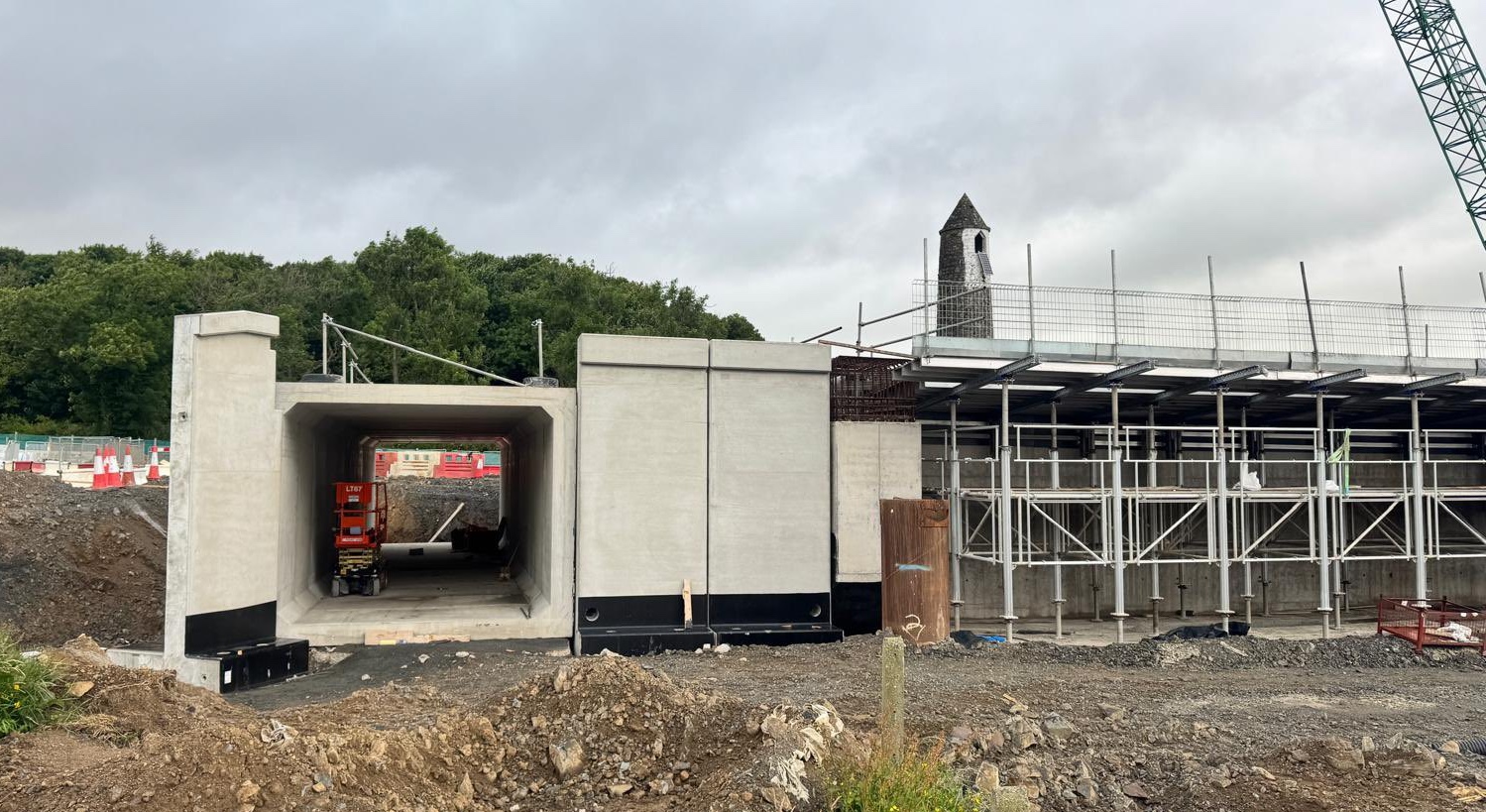 Ground level view through a concrete box
                          tunnel not yet buried. Construction work is
                          evident on a concrete bridge pier to the
                          immediate right.